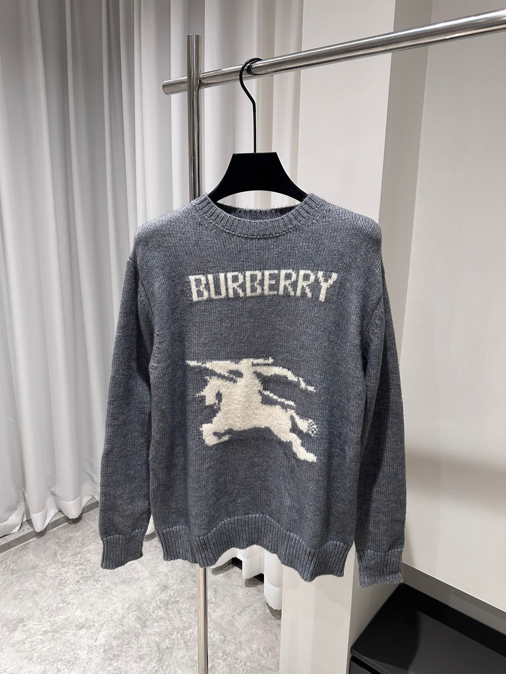 Gray crewneck knit sweater with BURBERRY text and white horse graphic on front