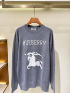 Gray knit sweater with “BURBERRY” lettering and white horse graphic on front.