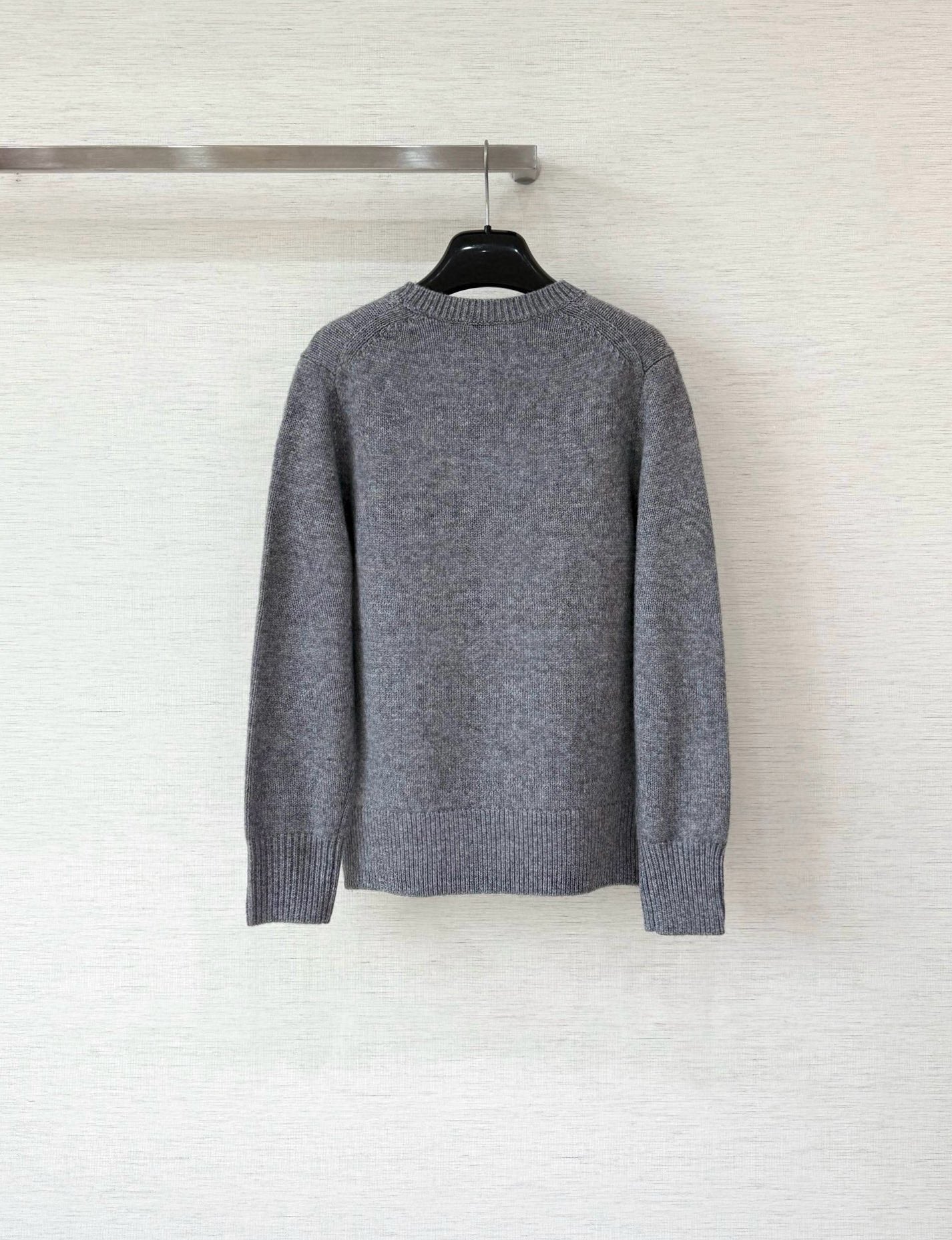 Grey long-sleeve sweater with ribbed crew neck and plain back
