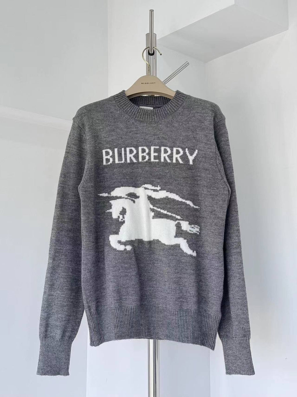 Gray crewneck knit sweater with BURBERRY label and white horse graphic on front