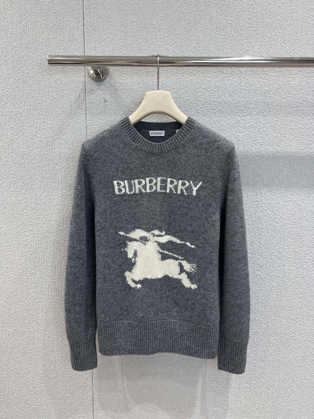 Gray Burberry sweater on hanger with crew neck and horse graphic