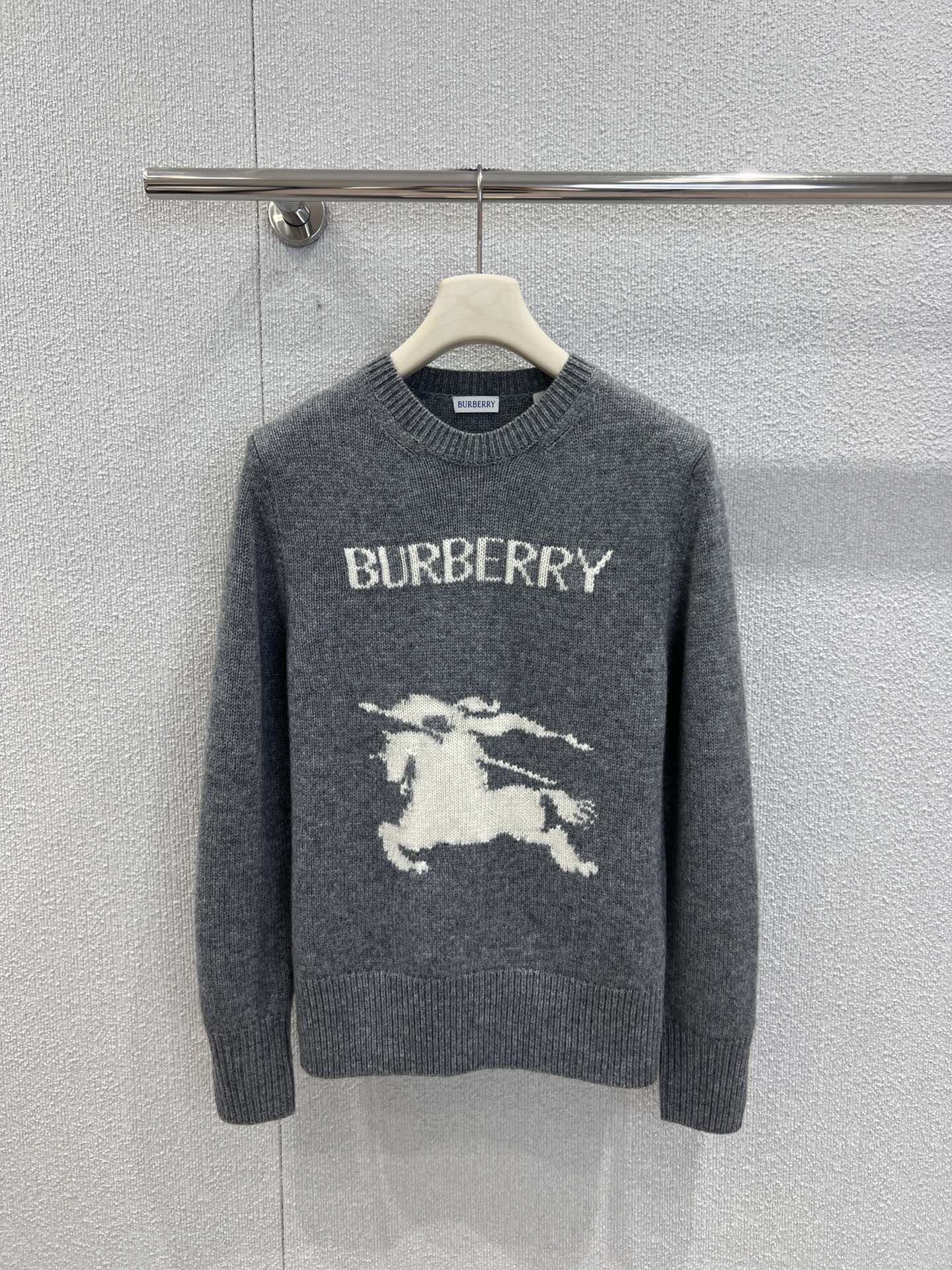 Gray Burberry sweater on hanger with crew neck and horse graphic