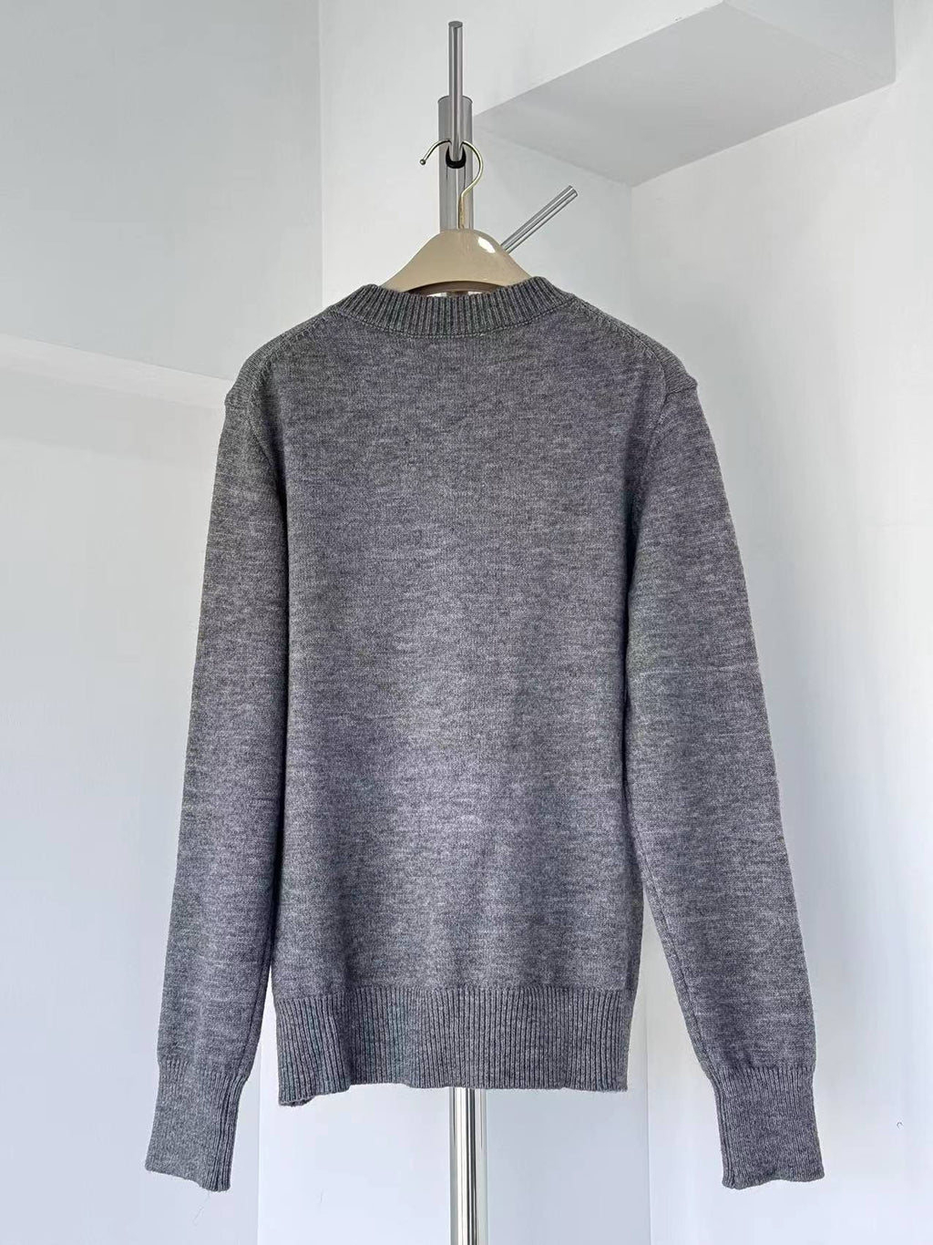 Gray crewneck knit sweater with ribbed cuffs and hem, plain back
