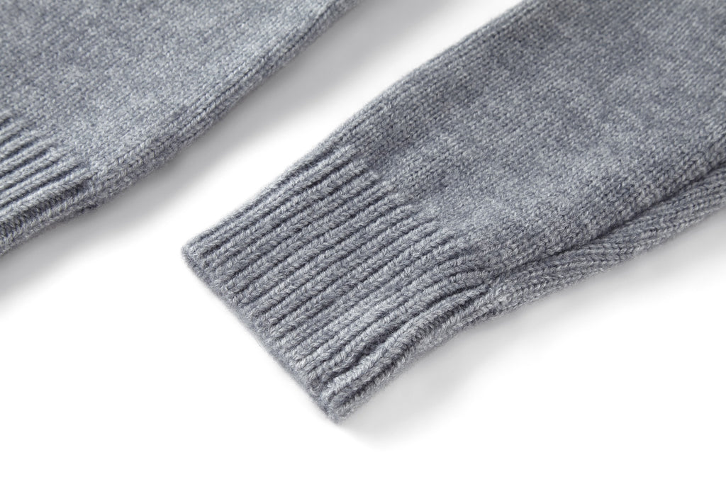 Grey rib-knit sweater sleeve cuff and hem detail