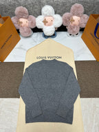 Grey knit sweater back view with ribbed hem and crew neck