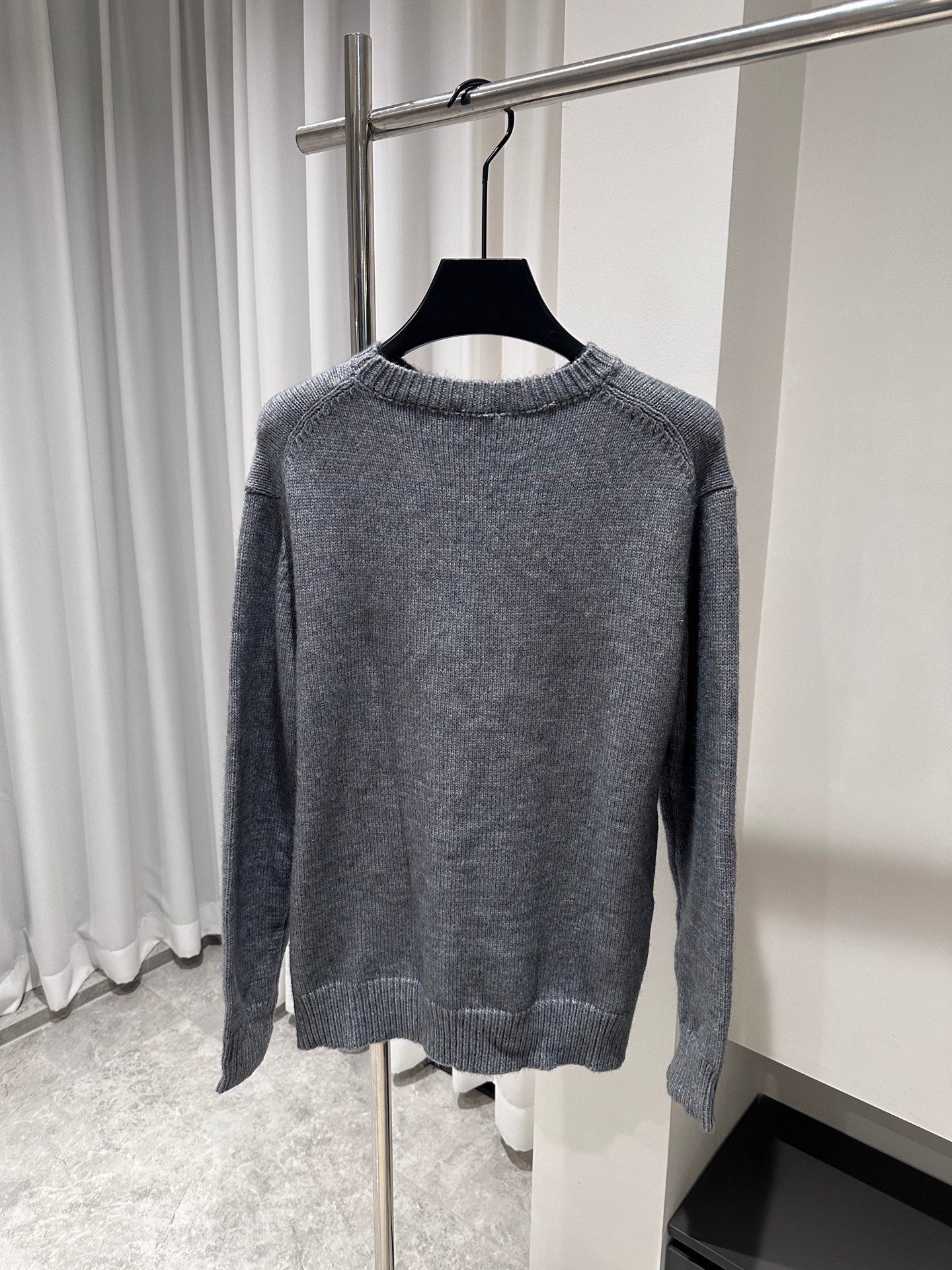 Gray crewneck knit sweater with ribbed hem and cuffs, plain back