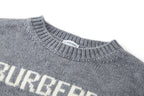 Close-up of gray crewneck collar ribbing with small “BURBERRY” label.