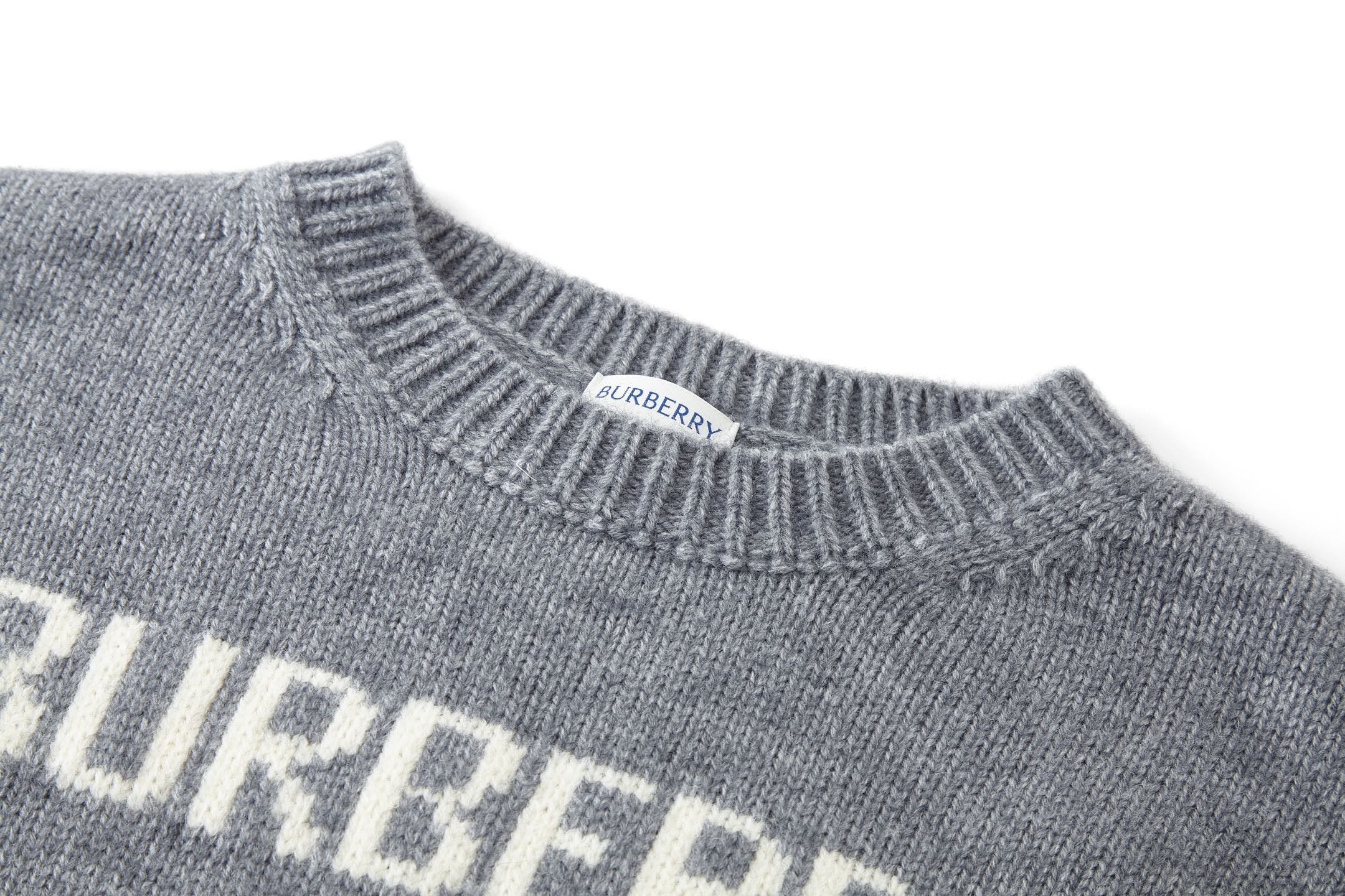 Close-up of gray crewneck collar ribbing with small “BURBERRY” label.