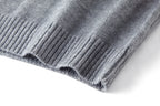 Close-up of gray sweater hem with ribbed knit edge and texture.