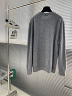 Grey knit sweater back view with ribbed crew neck and long sleeves