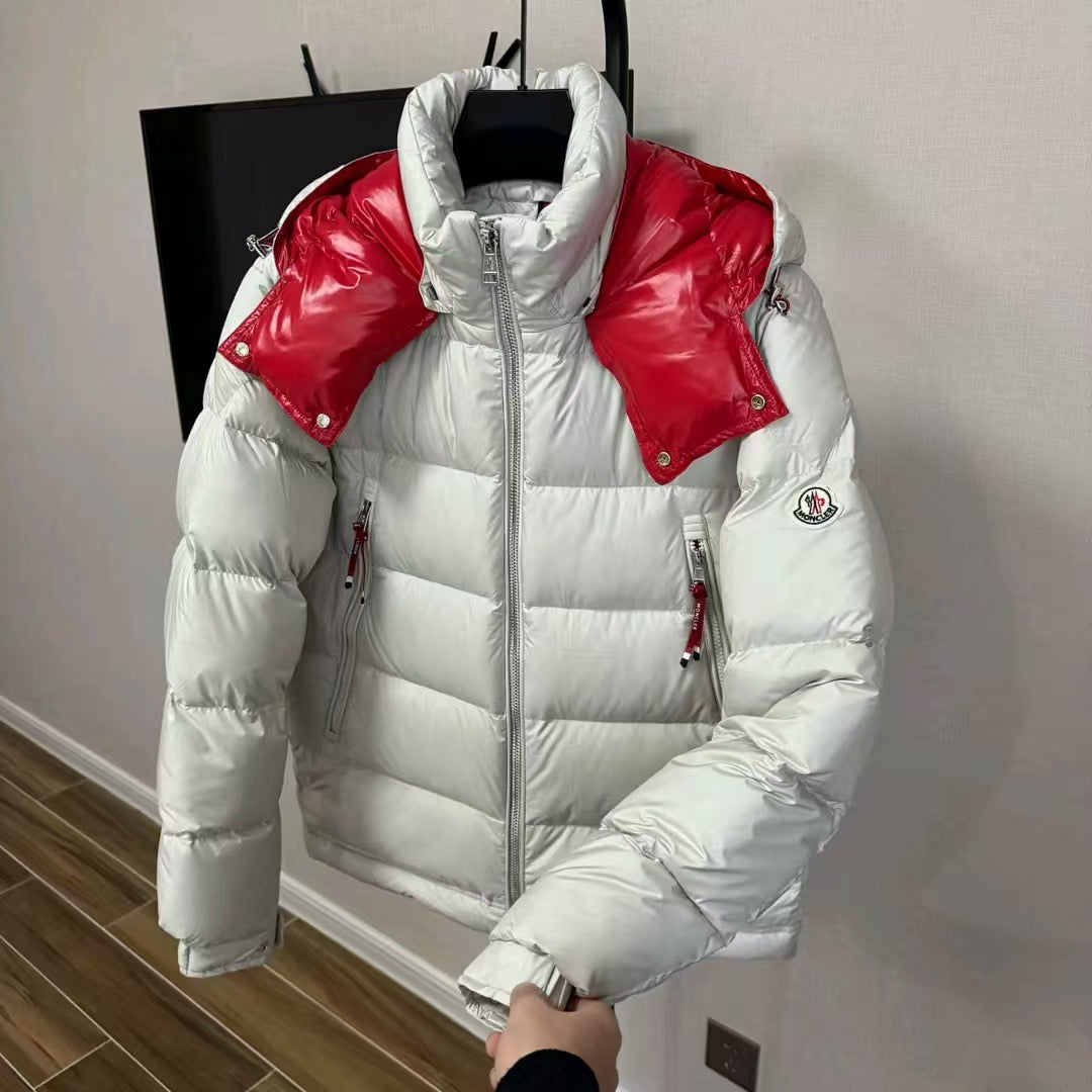 Long puffer jacket on hanger, white insulation with red shoulder panels and front zip