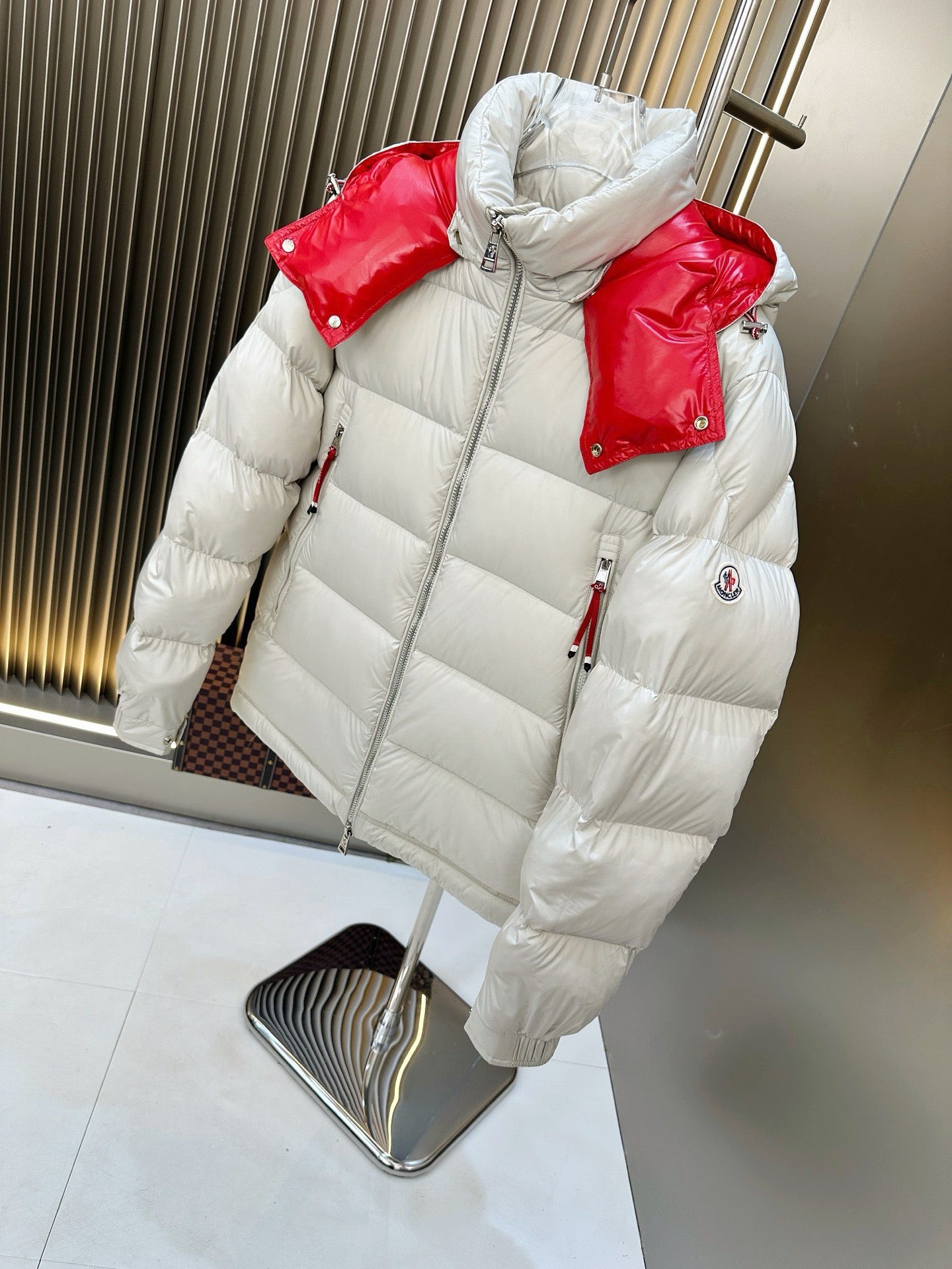 Long puffer jacket, white body with red shoulder panels, hooded full-zip design