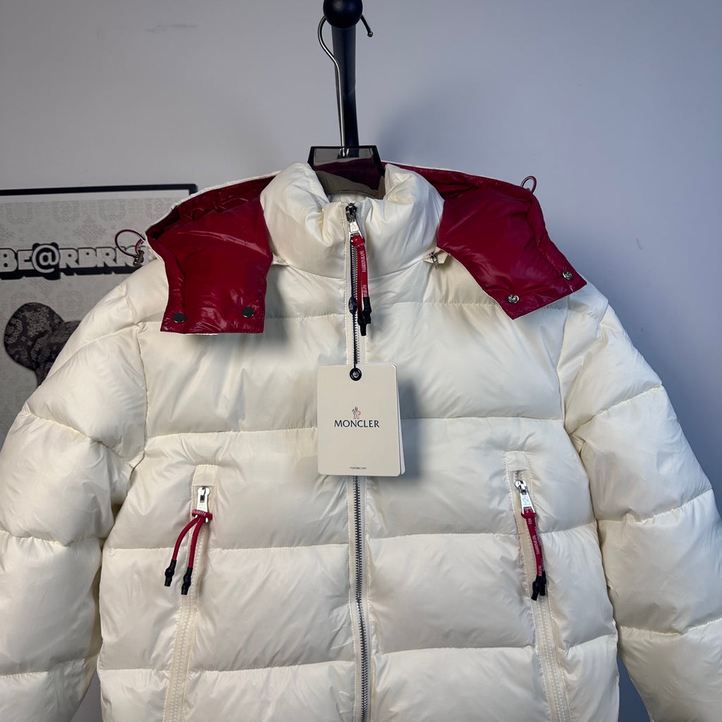 Moncler long puffer jacket front view, red shoulder panels and logo label