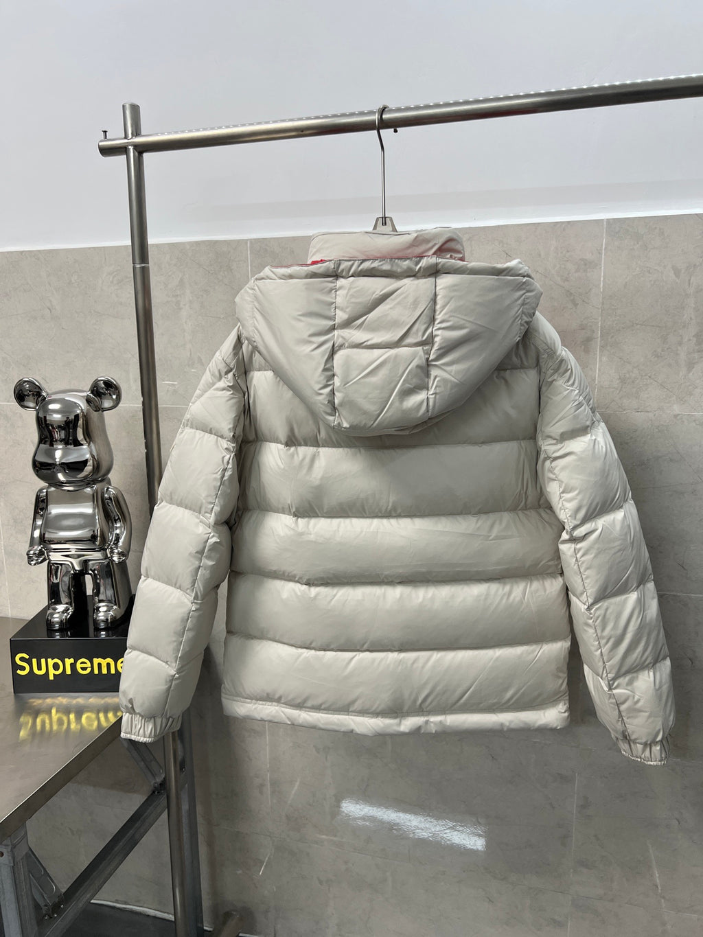 Long puffer jacket back view, white quilted insulation and hood with gathered edges