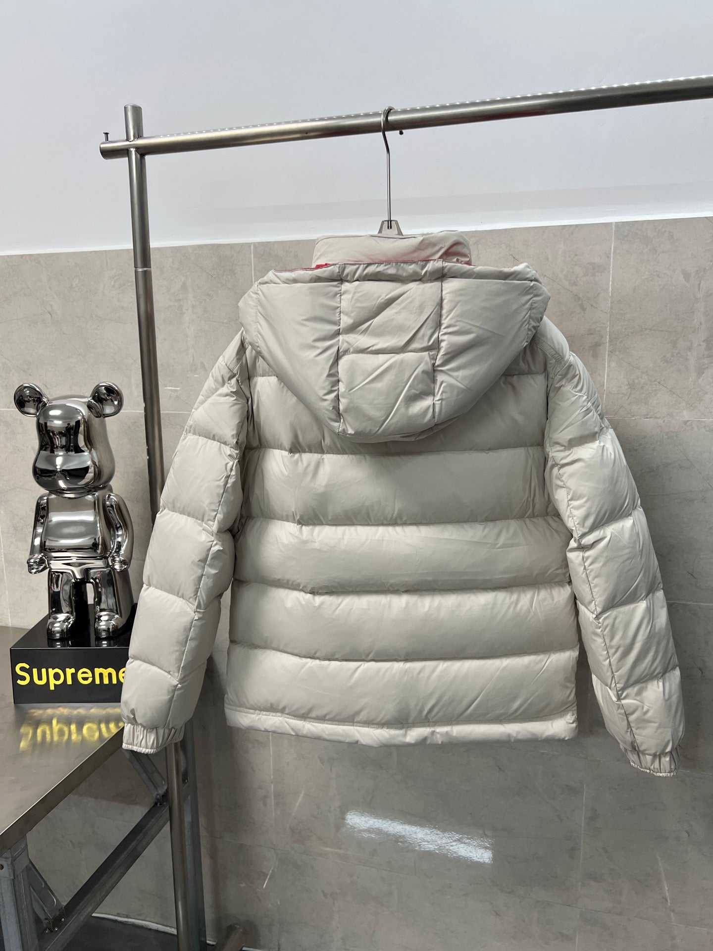 Long puffer jacket back view, white quilted insulation and hood with gathered edges