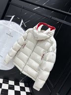 White long puffer jacket with quilted panels, red hood lining, and zip closure