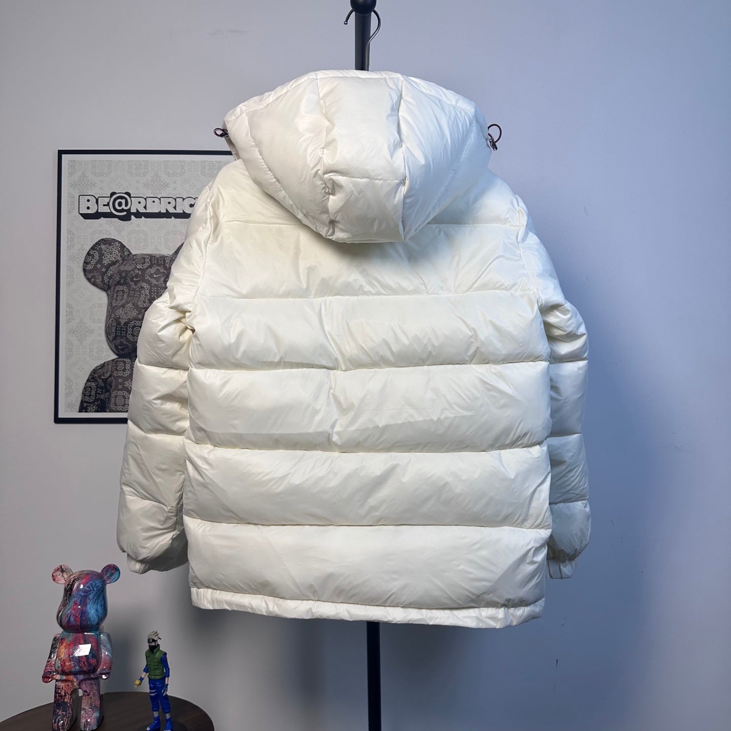 Moncler long puffer jacket back view with hood and horizontal quilting