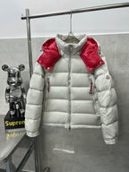 Long puffer jacket front view, white quilted insulation with red shoulder accents
