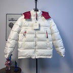 Moncler long puffer jacket with red hood and cuffs, front zip