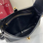 Black hobo bag interior with top zip pocket and gold-tone zipper pull