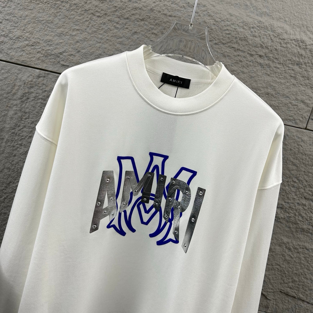 White Amiri crewneck sweatshirt with blue graphic lettering and silver metallic panels