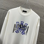 White Amiri crewneck sweatshirt with blue graphic lettering and silver metallic panels