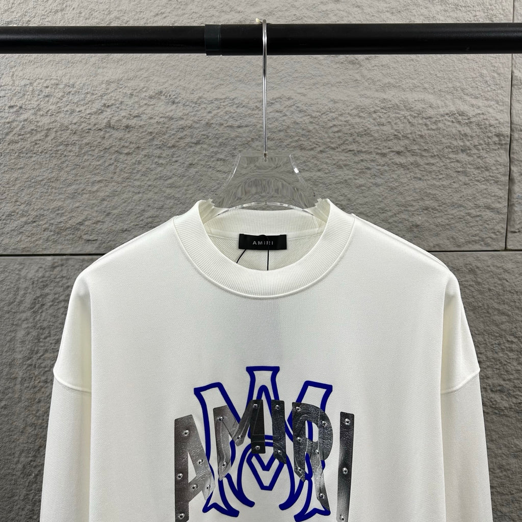 White Amiri crewneck sweatshirt front view with blue graphic and silver metallic accents