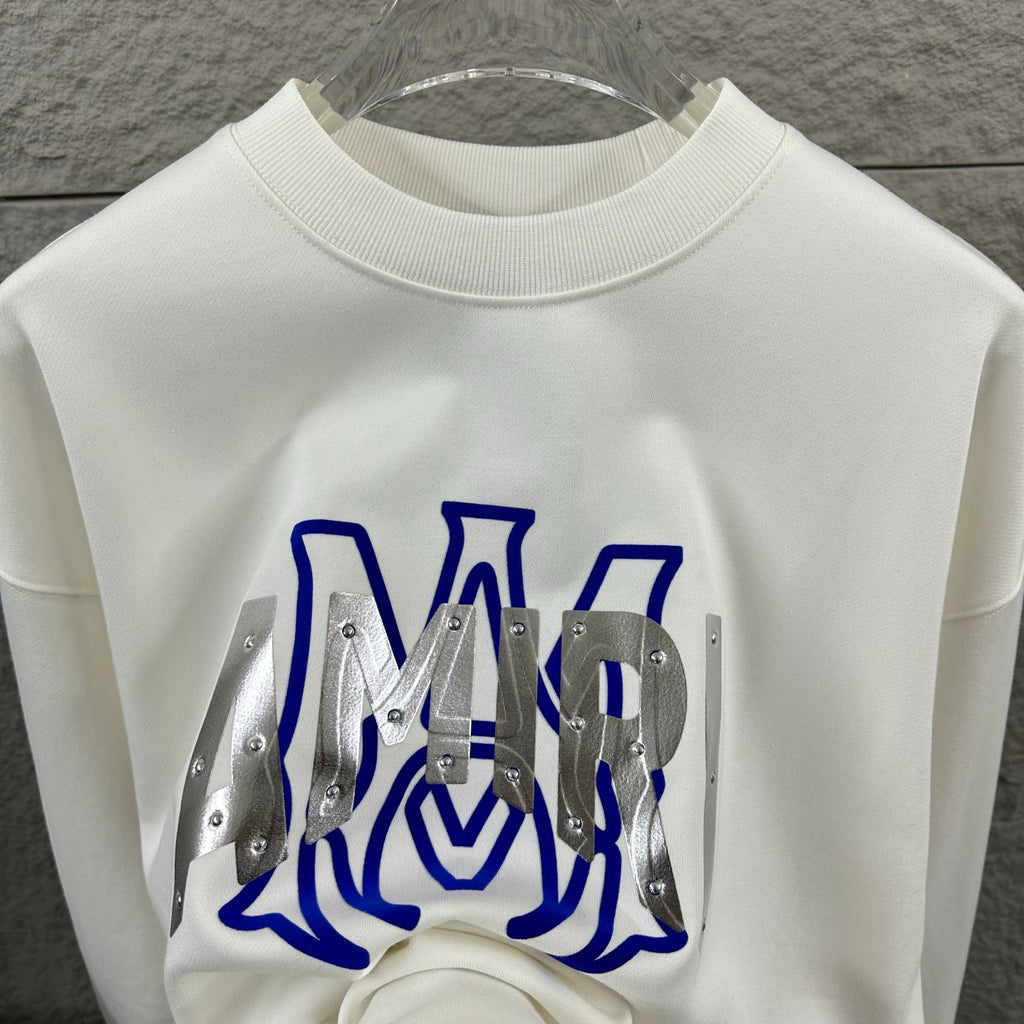White Amiri sweatshirt back view with blue graphic lettering and silver metal panels