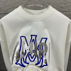 White Amiri sweatshirt back view with blue graphic lettering and silver metal panels