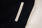 Black varsity jacket with cream sleeve panel and vertical striped detail