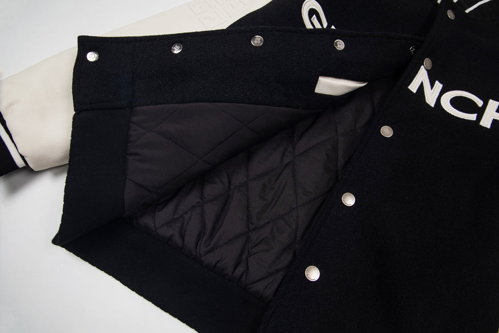 Black varsity jacket with quilted lining panel and metal snap buttons