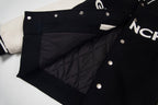 Black varsity jacket with quilted lining panel and metal snap buttons
