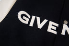 Close-up of GIVENCHY logo on black varsity jacket with round snap button