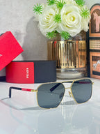 Sunglasses with dark lenses, gold metal frame, blue temple accents