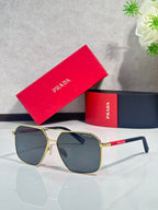 Sunglasses with dark lenses, gold metal frame, clear temple arms
