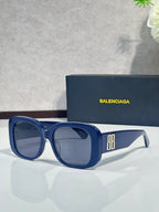 Blue sunglasses with square frames, dark lenses, and BB logo on the side