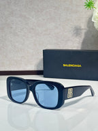 Blue sunglasses with dark lenses and BB logo on the side, glossy frame
