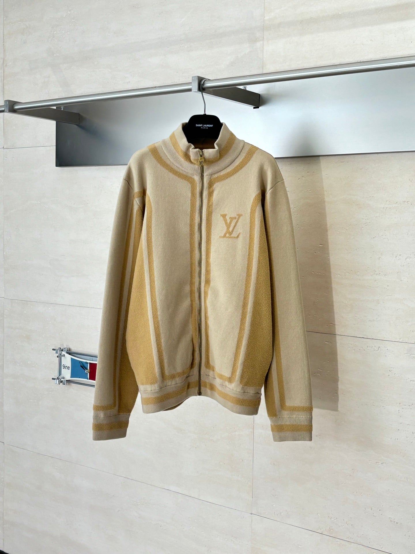 Beige knit zip jacket with tan trim and Louis Vuitton monogram on chest
