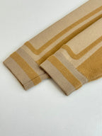Beige knit cuffs with gold stripe bands and ribbed knit edges