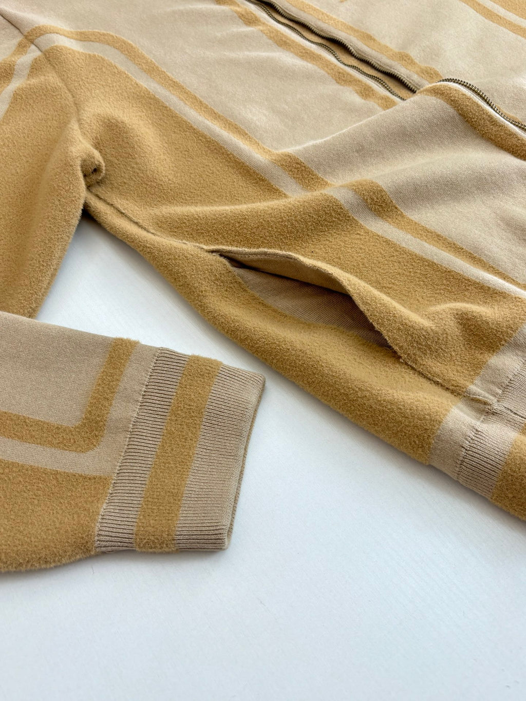 Louis Vuitton beige sleeve knit with gold stripe pattern and ribbed cuff