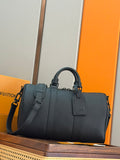Men's dark teal leather duffel bag with top handles and detachable shoulder strap