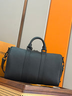 Men's dark teal leather duffel bag with top handles and adjustable strap