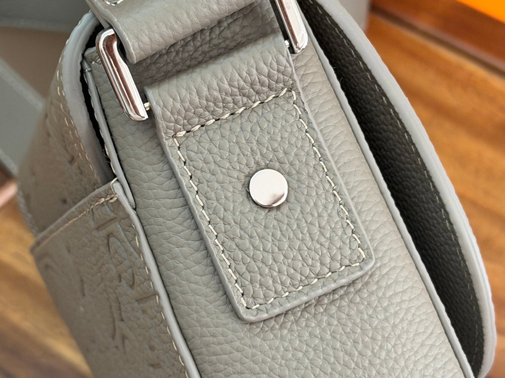 Dior men's bag strap end with stitched leather panel and round snap button