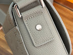 Dior bag side panel detail with snap pocket and crossbody strap, gray