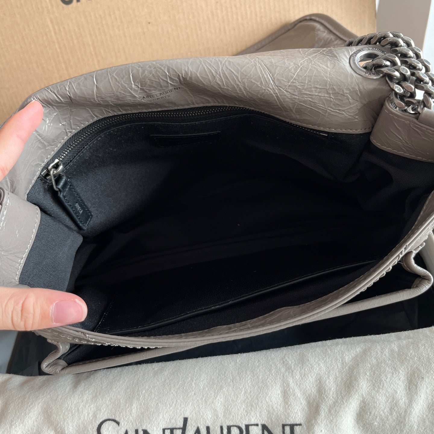 Silver leather shoulder bag interior with black lining and zip pocket