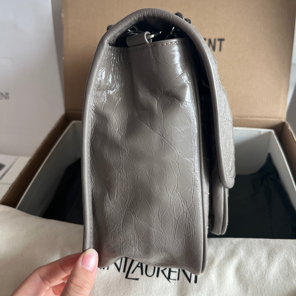 Silver leather shoulder bag back view with rounded handle and interior opening