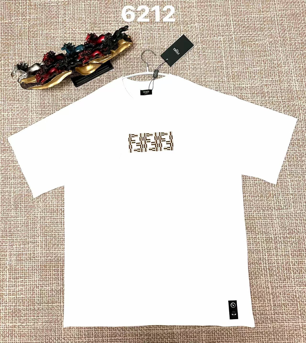 White short-sleeve T-shirt with Fendi FF logo at center chest, hem brand patch