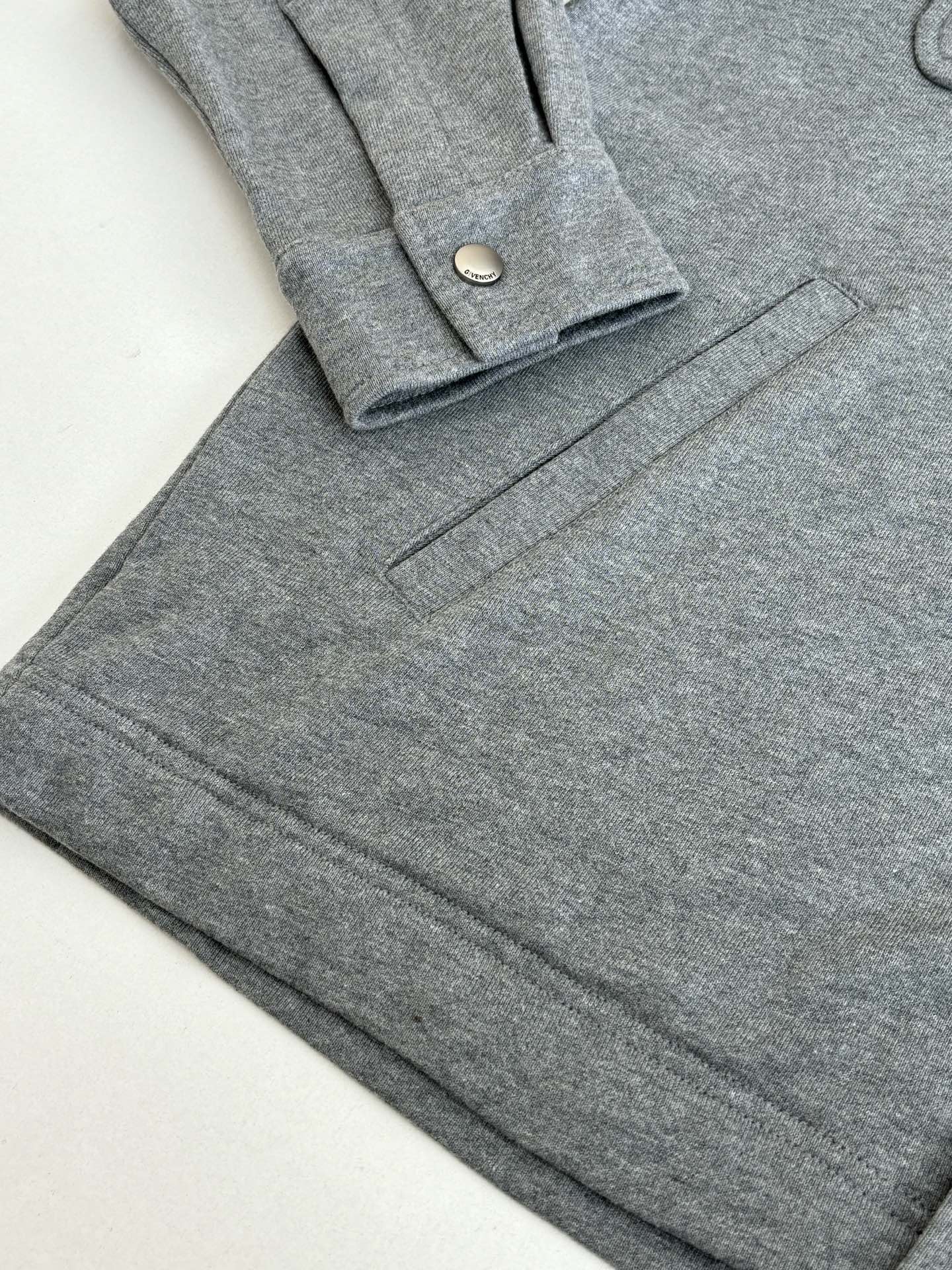 Gray Givenchy long-sleeve jacket with front flap pockets and button placket