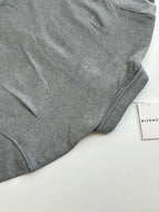 Gray Givenchy long-sleeve jacket sleeve and curved hem detail
