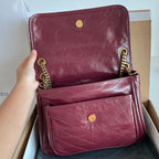 Two burgundy Saint Laurent leather shoulder bags with gold chain and flap
